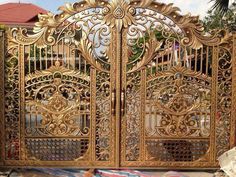 an ornate gold gate with intricate designs on it