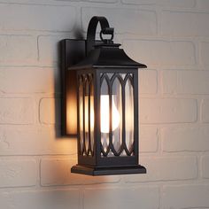 an outdoor wall light on a brick wall