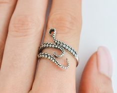 Add a touch of mystical allure to your style with this sterling silver octopus ring. This adjustable tentacle ring wraps around your finger with elegant grace, showcasing the intricate beauty of the sea. Whether you're a fan of punk fashion or a lover of all things oceanic, this ring is the perfect accessory to express your unique personality. Crafted with care and made of high-quality sterling silver, it's a must-have piece for any sea witch or pirate at heart! Rings are sold in sizes 5 6 7 8 9 Octopus Aesthetic, Tentacle Ring, Fantasy Rings, Squid Rings, Tentacles Ring, Pirate Ring, Witch Ring, Punk Mode, Ring Wraps