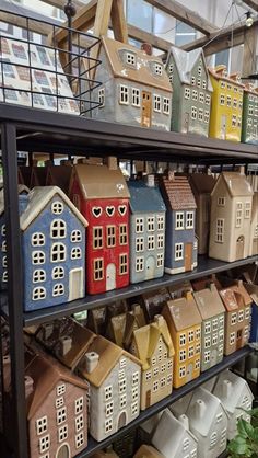 several shelves filled with different types of houses