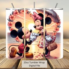 the mickey mouse and minnie mouse are kissing on the beach with an umbrella in front of them