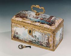 an ornately painted box with a key in it