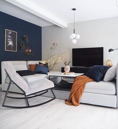 a living room with two chairs and a television