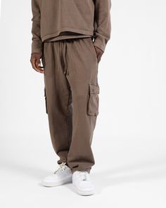 Crafted from a premium 450GSM 100% Cotton terry fabric, these cargo sweatpants use the same silhouette as our open bottom sweatpants but feature cargo pockets with button closure and double back pockets. A specialized mineral stone wash has been used to obtain a vintage look, ensuring each piece is one-of-a-kind. 100% Cotton 450GSM Preshrunk and no pilling after wash Relaxed fit Due to this garment's unique wash process there may be slight color variation between different pieces Open Bottom Sweatpants, Cargo Sweatpants, Terry Fabric, Mineral Stone, Signature Collection, Vintage Brown, 1/4 Zip, Tee Shop, Vintage Look