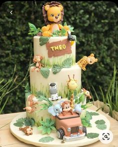 a three tiered cake with animals on it