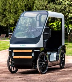 an electric golf cart is parked on the dirt