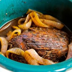 a pot roast with onions and beef in it