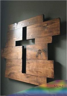 a piece of wood that has been made into a wall hanging on the side of a wall