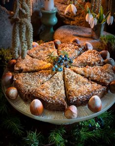 a cake on a plate with nuts around it