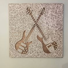 two guitars are depicted on a piece of wood