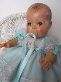 a baby doll with a pacifier in its mouth