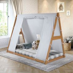 a child's bed with a tent on the top