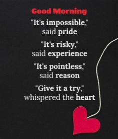 a red heart hanging from the side of a black wall with a quote on it