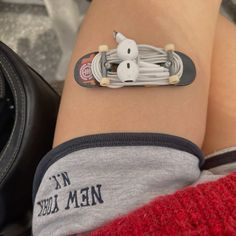 a person with a skateboard on their knee wearing a bracelet made out of toothpicks