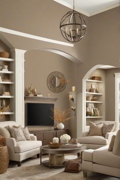 a living room filled with furniture and a flat screen tv mounted on a wall above a fireplace