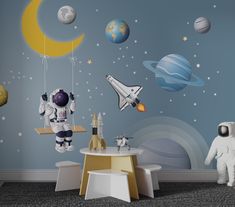 an astronaut themed nursery room with space and planets painted on the walls, including a rocket ship