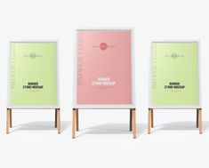 three posters on wooden stands with one showing the same type of poster and another displaying it