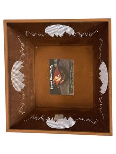 a wooden frame with an image of a man in the middle and white dots on it