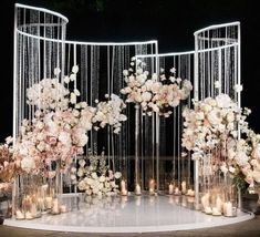 a wedding ceremony setup with flowers and candles