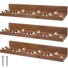 three wooden shelfs with white mountains on them and screws in the bottom one