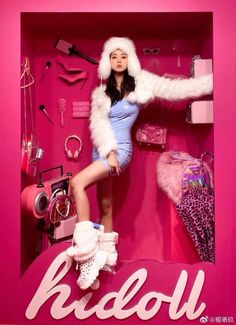 a woman is posing in a pink display case with shoes and accessories on the shelf