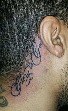 a close up of a man's ear with writing on the side of his head