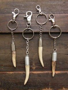 four different types of key chains with some animal horns hanging from it's ends