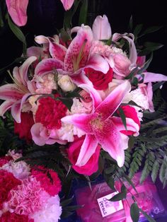 pink and white flowers in a vase on a table