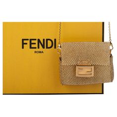 Fendi micro baguette made of weaven gold steel. On front is the typical F logo clasp to close the bag. The piece comes with a adjustable and detachable shoulderbag (23”). The piece is new and comes with a box and dustcover. F Logo, Accessory Pouch, The Bag, Small Accessories, Fashion Handbags, A Box, Purse Wallet, Fendi, Pouch