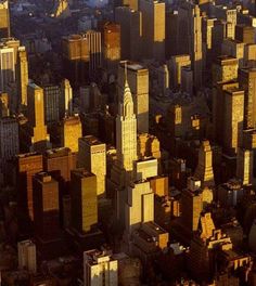 an aerial view of skyscrapers and buildings in new york city, ny at sunset