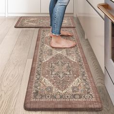 a woman standing on top of a rug in a kitchen