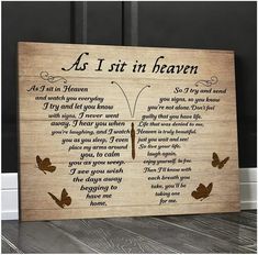 a wooden sign with the words as i sit in heaven and butterflies flying around it