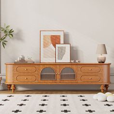 a living room scene with focus on the sideboard and art displayed in the background