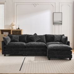 a living room with a sectional couch and ottoman