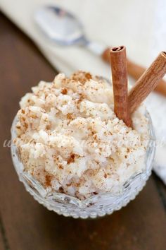 a close up of a bowl of food with cinnamon sticks