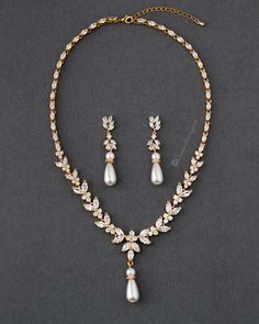 Ivory teardrop pearls hang from a CZ leaf design in this classically styled, gorgeous wedding necklace set. You will love the classic style of this jewelry set for your wedding day! The necklace is 16 inches long with a 2-inch extender, the drop is 1.75 inches, the earrings are 2 inches long, grade AAA CZ, rhodium, gold, or rose gold plated, lead, and nickel free. Gold Bridal Hair Accessories, Wedding Necklace Set, Buy Pearls, Gold Necklace Set, Rose Gold Wedding, Wedding Bridesmaid Dresses, Bead Jewellery, Bridal Hair Accessories, Wedding Bridesmaids