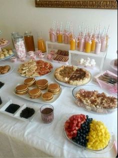 a table topped with lots of different types of foods and desserts next to each other