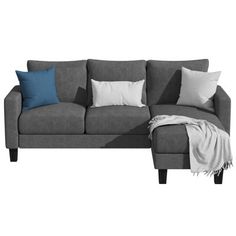 a gray couch with blue and white pillows on it's back end, next to a throw blanket