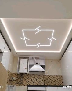 an overhead view of a kitchen with white lights on the ceiling and tile flooring