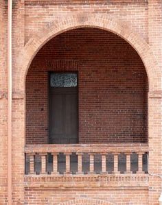 an old brick building with a black door