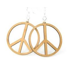 two wooden peace signs hanging from chains on a white background, one is made out of wood and the other has silver earwires