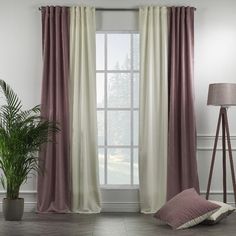 a living room with a large window covered in pink and white drapes next to a potted plant