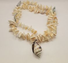 Vintage Beaded Seashell Necklace- Summery Seashell Necklace with Small Iridescent Beads and Nautilus Shell Pendant - Mermaid Jewelry - K#665 - Chipped shells  - Iridescent beads  - 24 inch necklace  - Nautilus pendant 1 1/2 inch - Clean and in good condition Pearl Beaded Shell, Beaded Pearl Shell-shaped Necklace, Pearl White Beaded Shell Necklace, Beaded Mother Of Pearl Shell Necklace, Mother Of Pearl Beaded Shell Necklace, Unique White Beaded Shell, Beaded Pearl White Shell Necklace, Beaded Seashell, Nautilus Shell