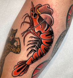 a man with a lobster tattoo on his leg