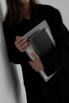 a woman is holding an electronic device in her hands