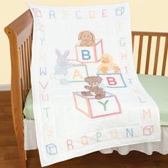 a crib with a baby blanket on top of it