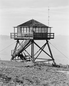 a tall wooden structure sitting on top of a hill