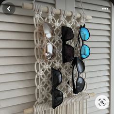 several pairs of sunglasses hanging on a wall