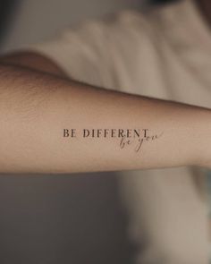 a person with a tattoo on their arm that says be different by you, in cursive writing