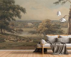 a couch sitting in front of a painting on the wall next to a lamp and chair